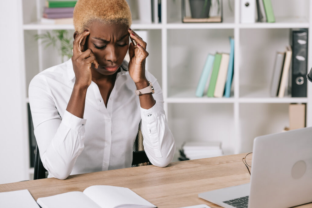 Stressed businesswoman holding head