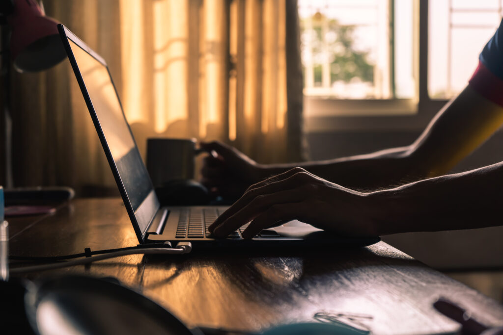 Working from home. Working in a room with natural light from a window.
